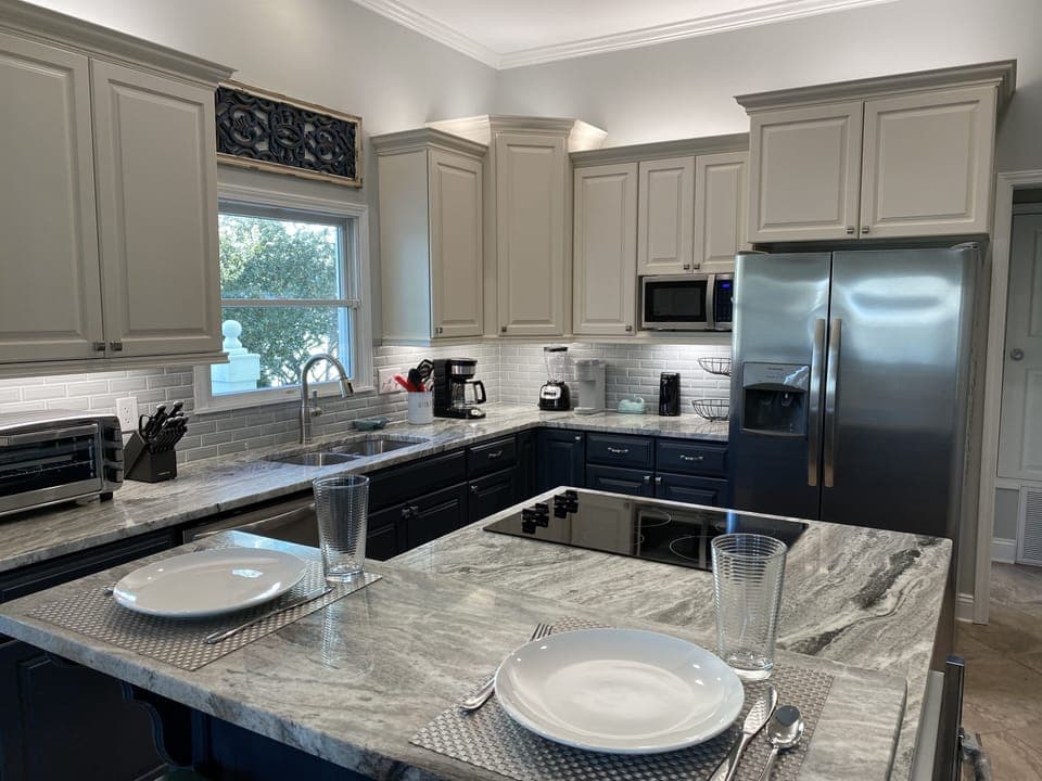 Kitchen view with bar seating, new granite, back splash and appliances