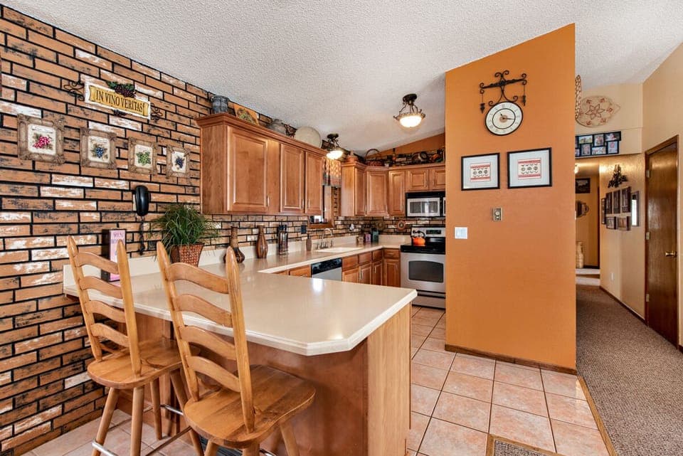 Kitchen, bar and hallway leading to bedrooms