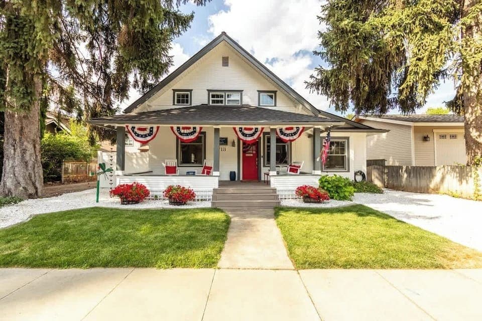 Front of home with rocking chairs and porch swing