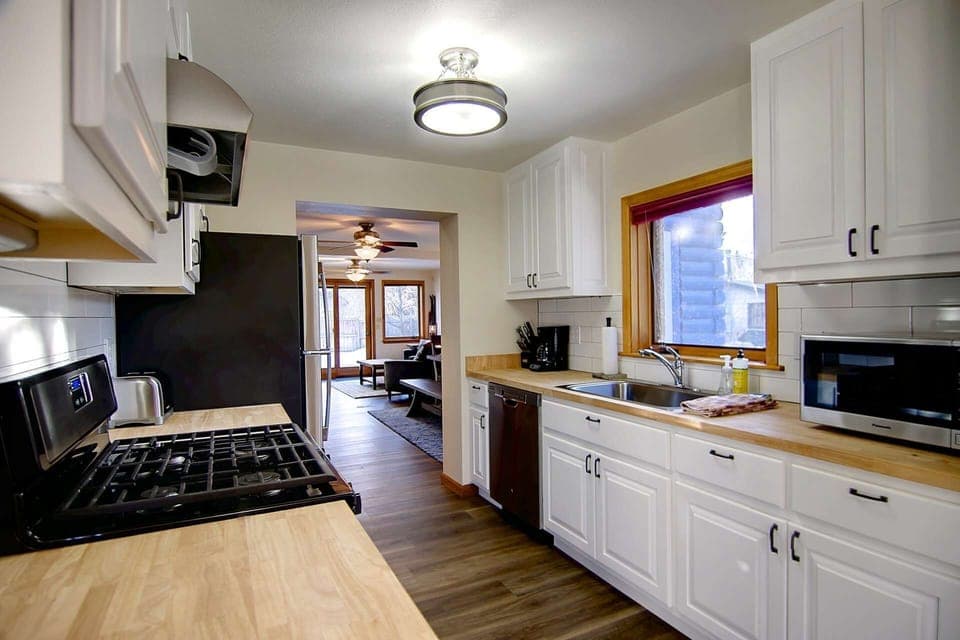 Cook up a feast in the fully stocked kitchen featuring a gas stove, modern appliances, and plenty of prep space.