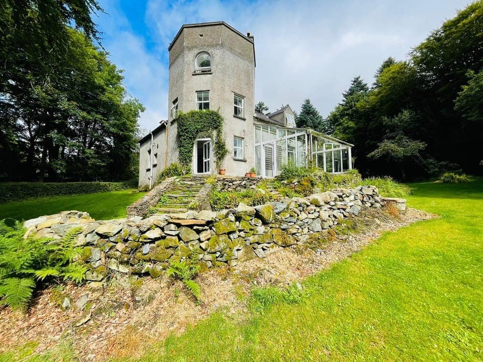 Glenbeg Tower showing terrace and surrounding gardens and woodlands