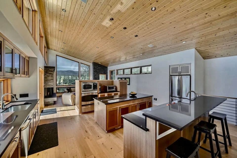 Gourmet kitchen with high-end appliances, island seating, and open layout