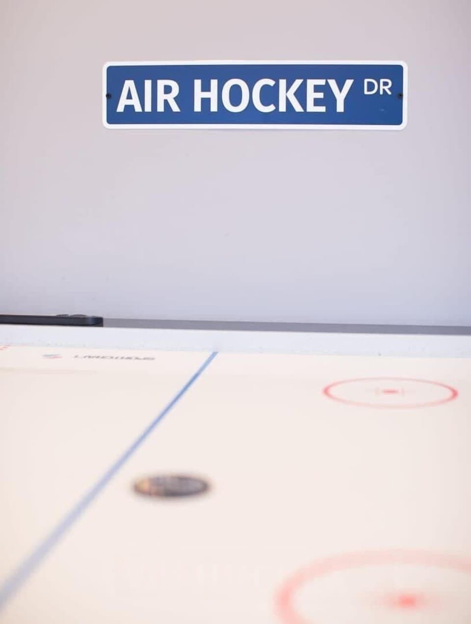 Face off in a friendly air hockey match in the shared rec space.