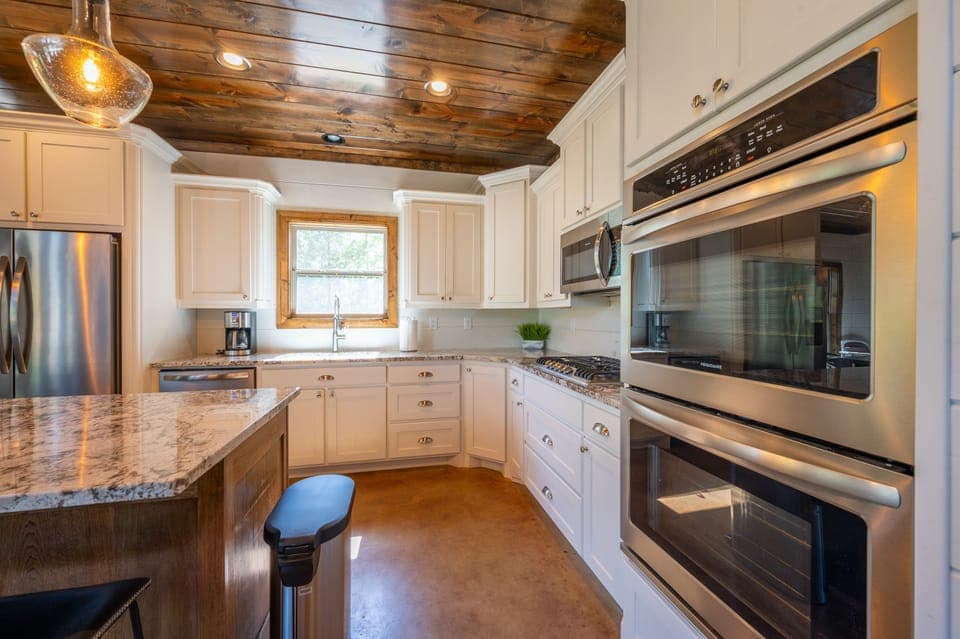 The fully equipped kitchen with granite countertops makes cooking for your group easy.