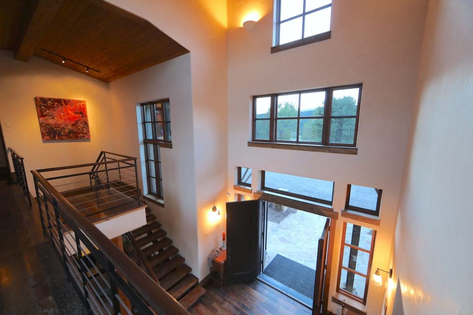 Looking down from the master wing through the front door. Lots of original art! 