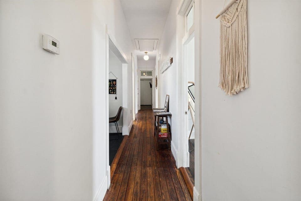 Bedrooms are on the left, kitchen and bathrooms are on the right off the hallway