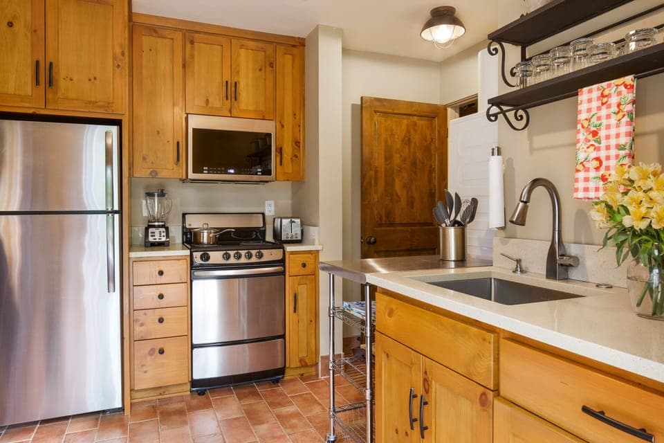 Charming kitchen has modern stainless appliances, and a stackable Washer/Dryer.
