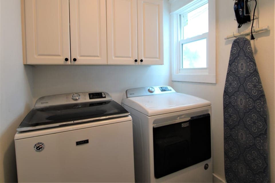 Bright space with modern machines for effortless vacation laundry days!