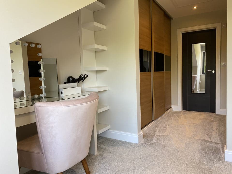 Dressing area within master bedroom leading to walk-through wardrobes & en-suite
