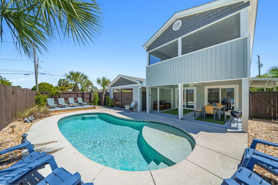Modern coastal retreat with sparkling pool and tropical palms creating your perfect Florida getaway.