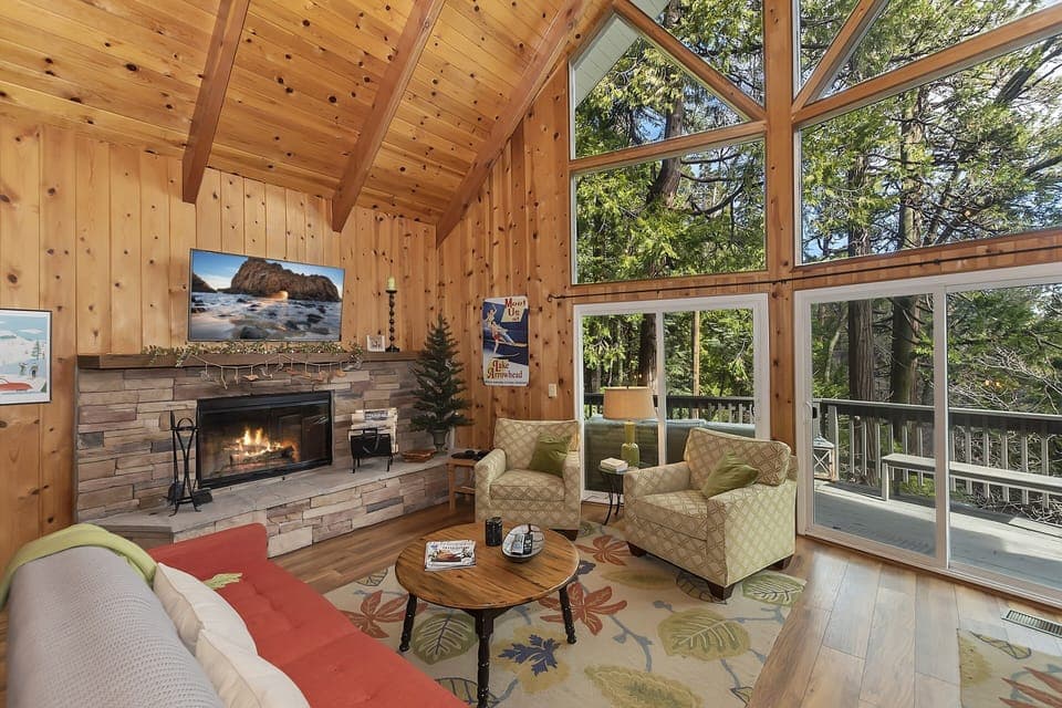 Living room with windows from floor to ceiling and cozy fireplace