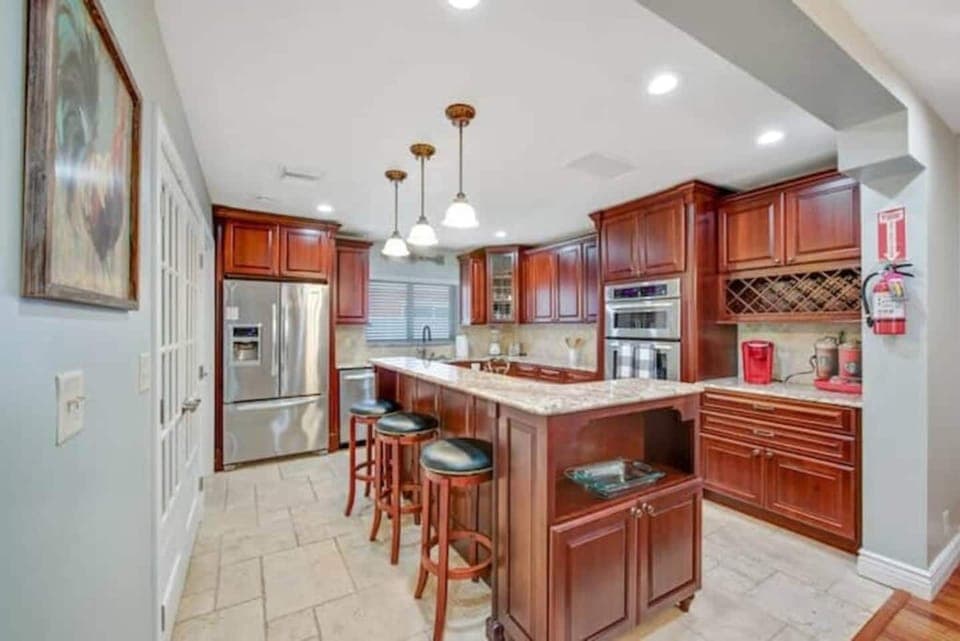 Kitchen with open lay out and island. Full set of appliances and coffee station.