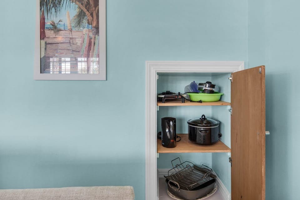 cupboard in living area for large platers, bowls, griddle, crockpot, etc.