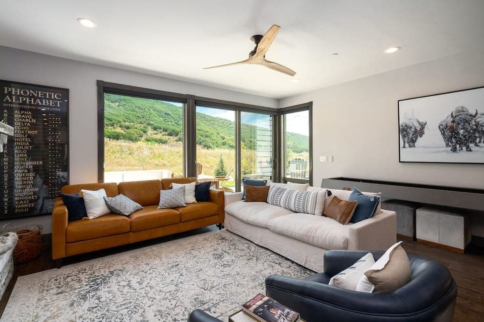 Big windows and large sliding doors open up to the deck, out door space.