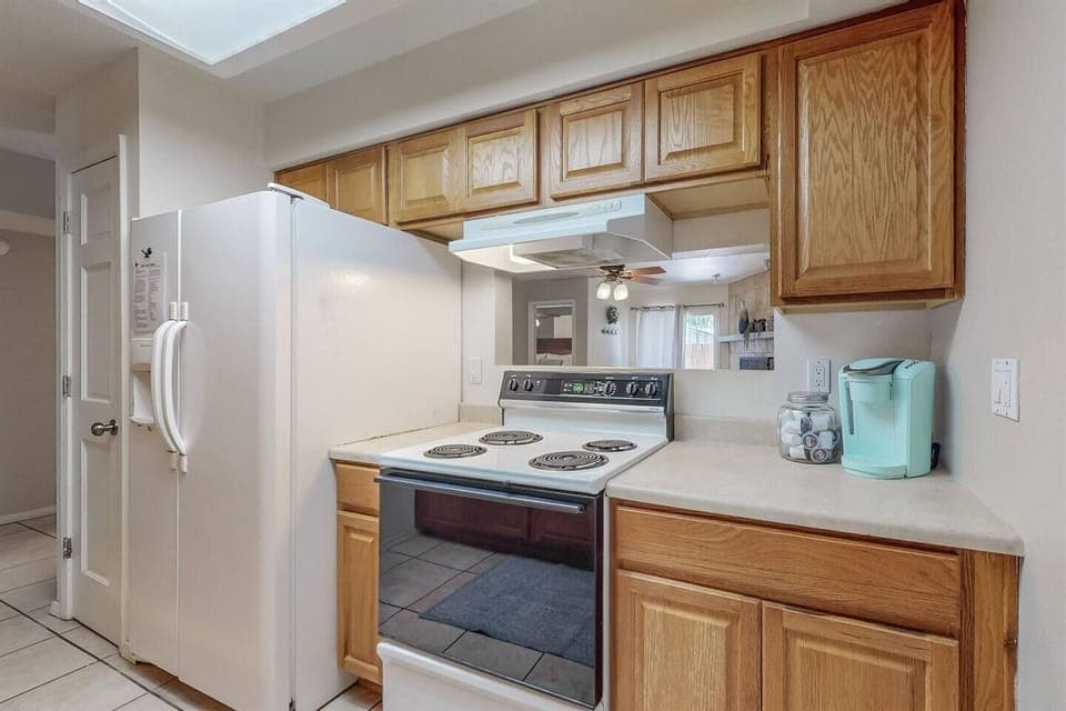Kitchen includes electric stove, refrigerator, dishwasher, microwave and coffee maker