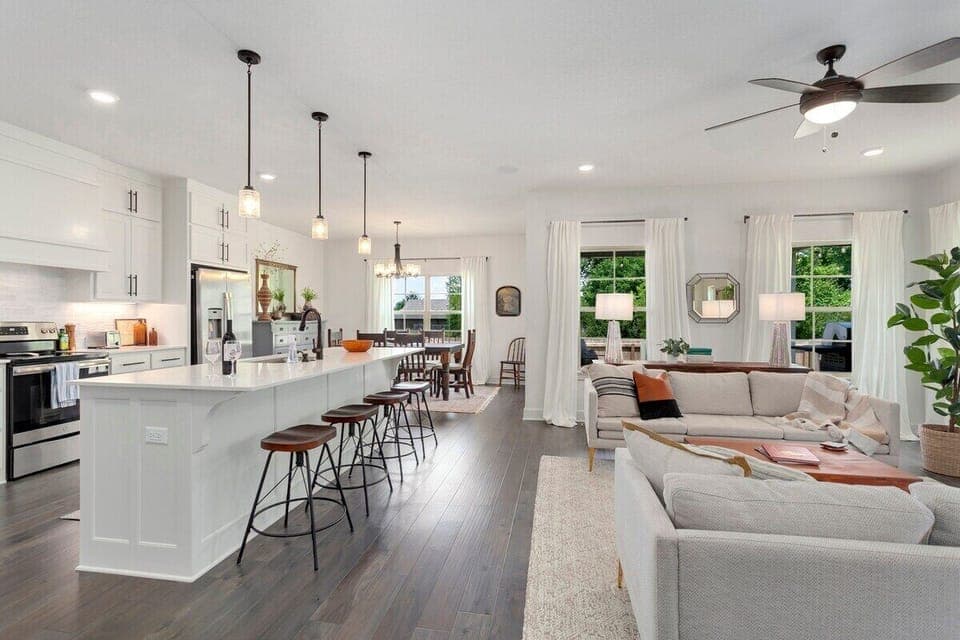 The Solitude Retreat is a brand-new home featuring a modern, open floor plan with tons of seating, a fully stocked kitchen with island, 4-burner stove top, and a dining table that can seat 7.