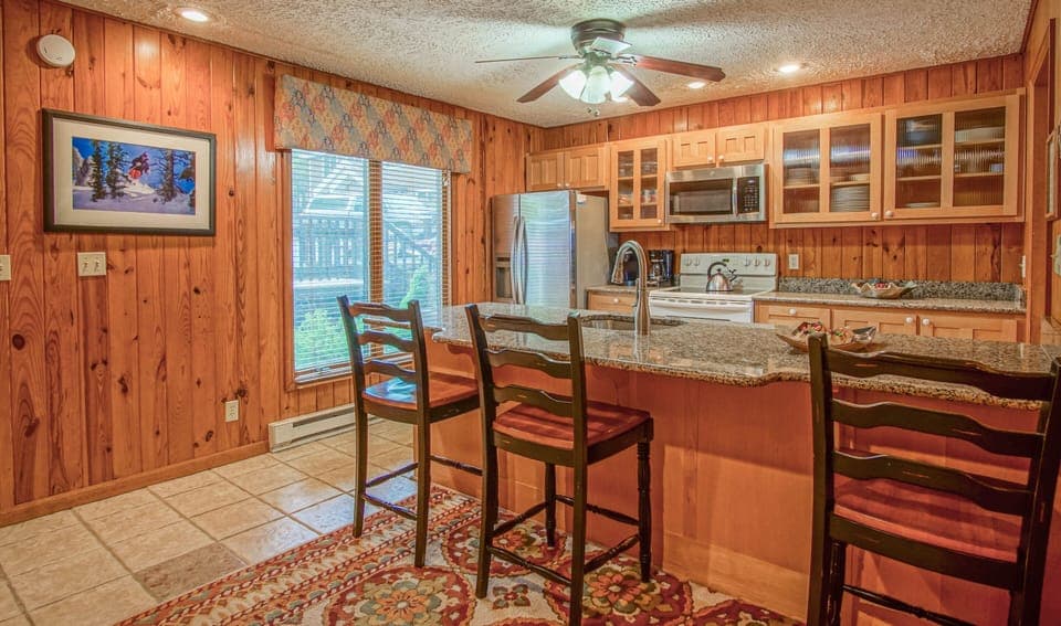 The kitchen is located on the 2nd level. The kitchen bar has seating for 3.