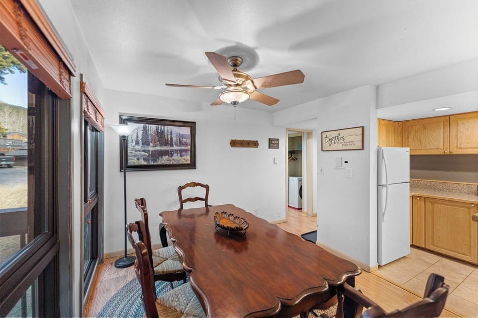 The dining area is just off the deck for a bright feel with beautiful views.