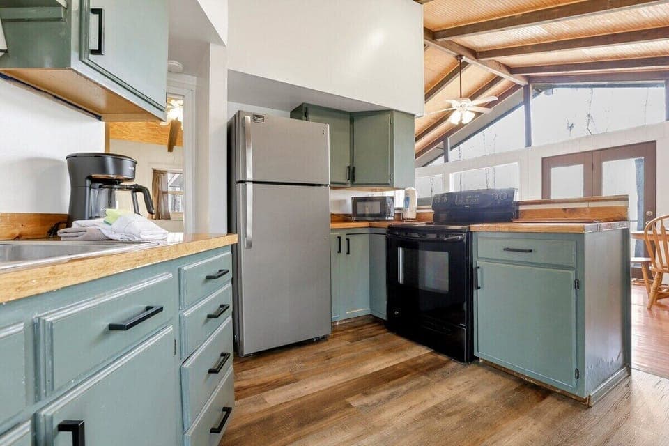 Kitchen with refrigerator and electric range.