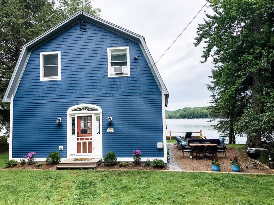 Large side patio with outdoor dining, charcoal grill, and lots of comfy seating.