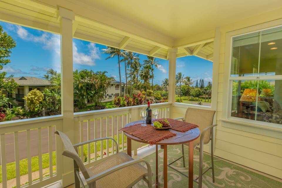 Relax on the expansive main lanai, featuring lush tropical scenery.