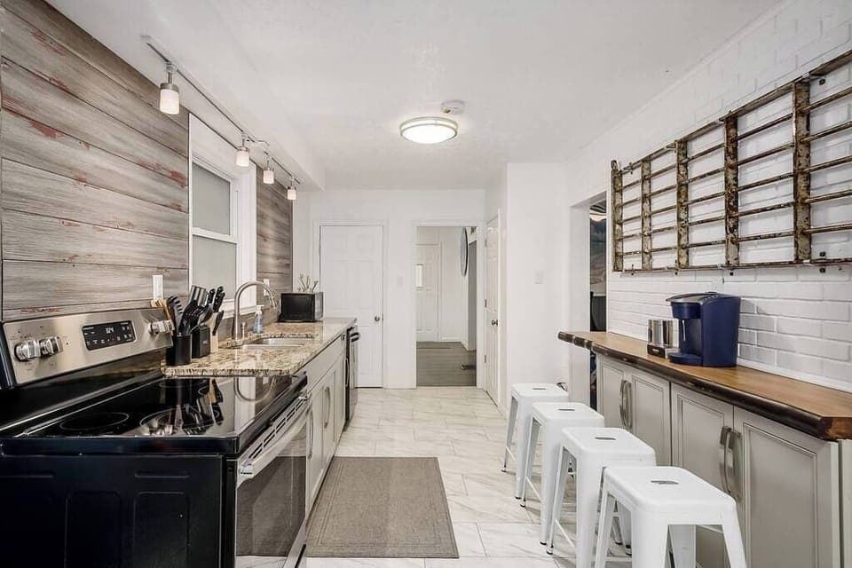 Your open kitchen includes granite countertops, SS appliances, and a Keurig