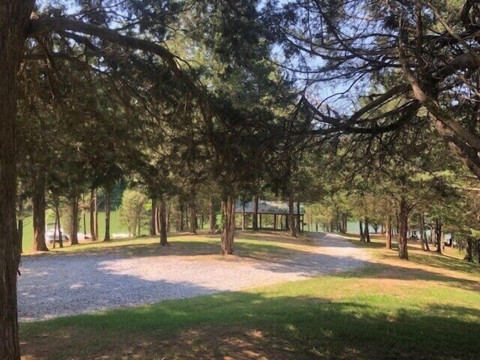 Gentle slope walk down to the pavilion, firepit, and water from the lodge. 