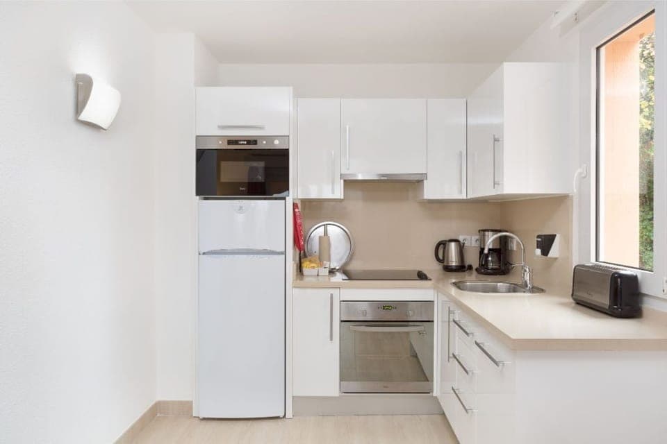 Contemporary kitchen with sleek appliances, ready for culinary exploration.