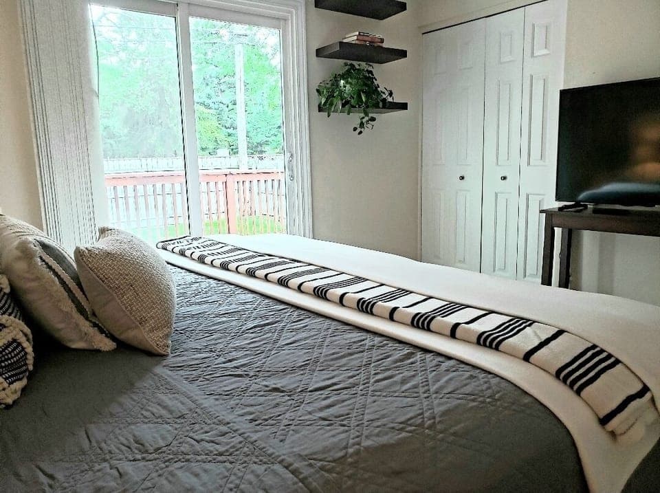 Master with king bed and doorwall to deck.