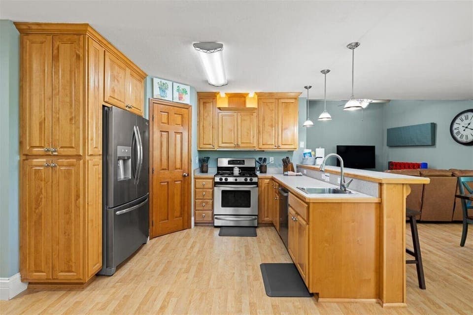 Double kitchen: stove, oven, warming drawer, pantry, dishwasher, and fridge.