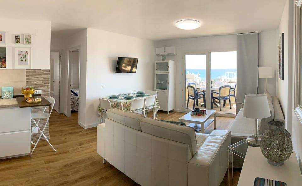 Living-dining room with direct access to the balcony, beach view, sofa bed, air conditioning and comfortable furniture