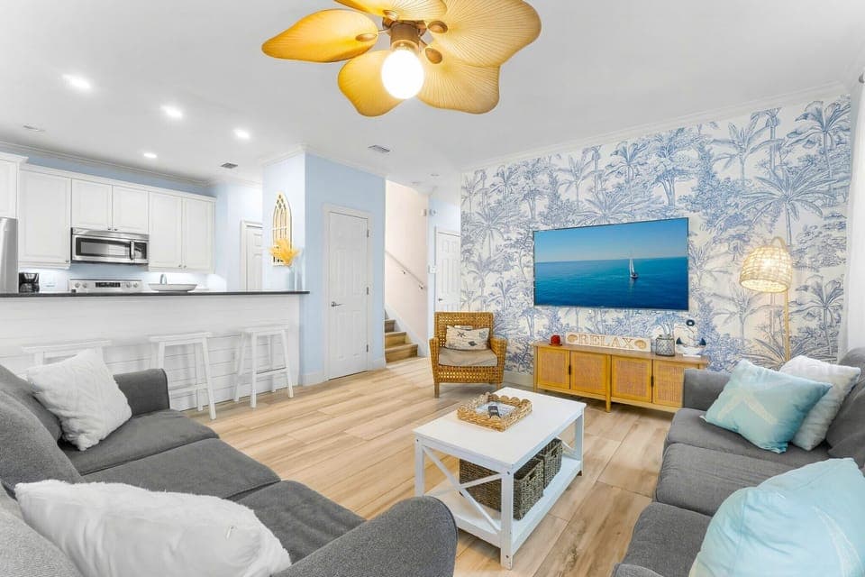 Wider shot of the living room. Did you know that this home is just 5 minutes from Destin Commons? There's tons of shops, restaurants, and gift stores to explore - and its all right outside the