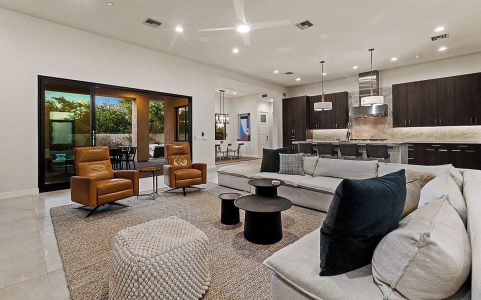 Open-concept great room w/ soaring ceilings, custom cabinets, & modern touches.