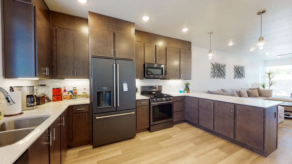 Spacious kitchen with upgraded fridge and full stocked kitchen and coffee bar.