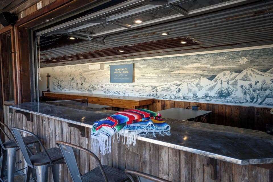 Garage door style windows in party barn add rustic cool and open for views