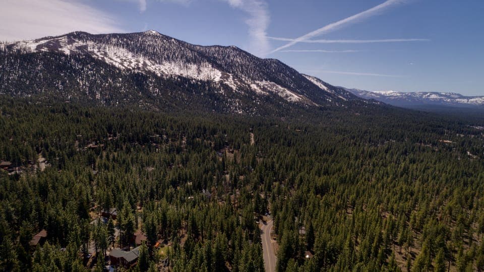 Breathtaking aerial view of the surrounding forest and majestic mountain peaks