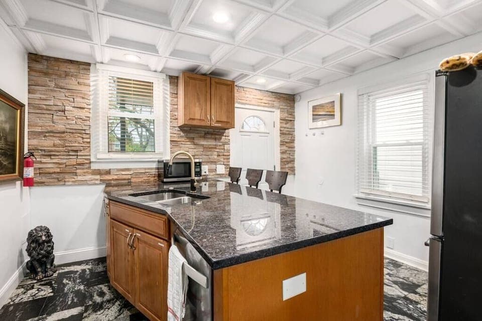 Your chef's kitchen includes granite counters, tile floors, stone walls and SS appliances