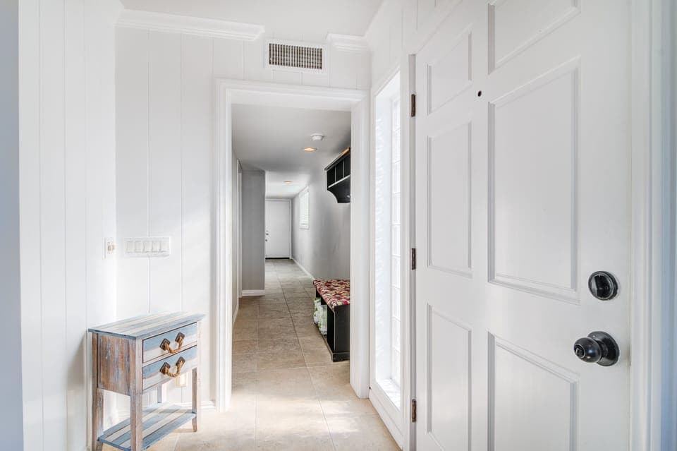 Hallway leading to two bedrooms and garage. 