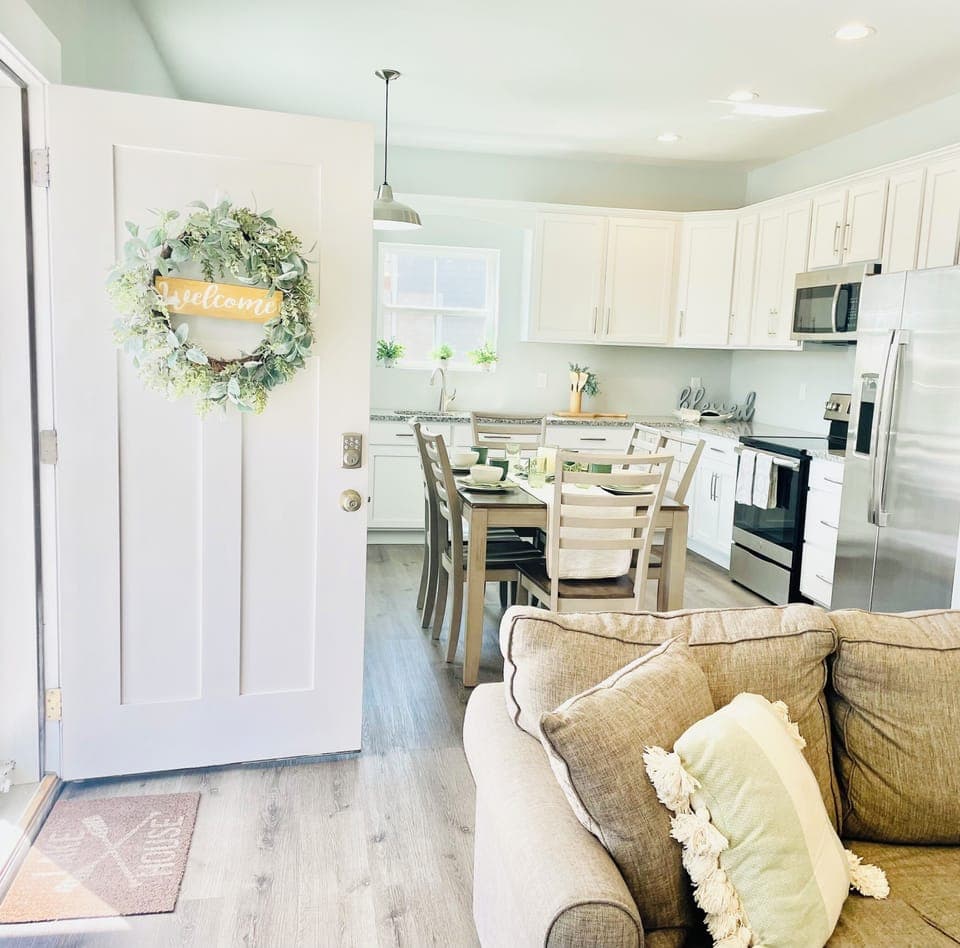 To your right is the living room, to your left is the fully equipped kitchen.