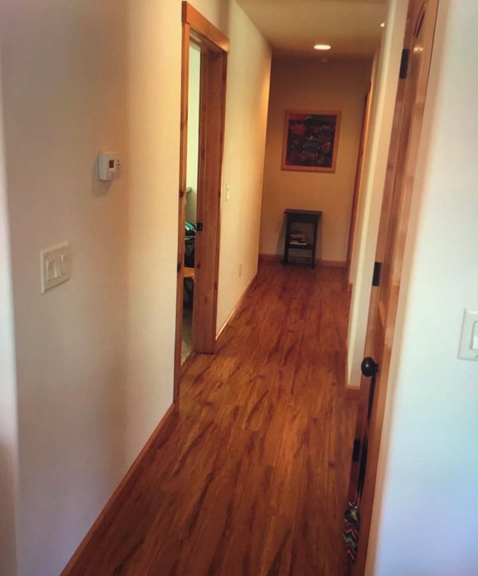 Hallway - lots of beautiful wood floors and doors 