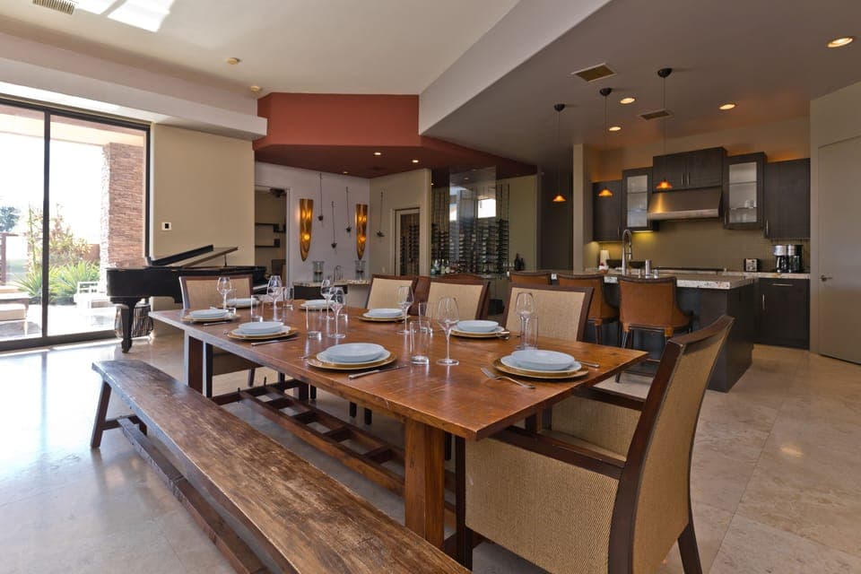 Open great room with high ceilings and a dining table that seats 8-10 people.