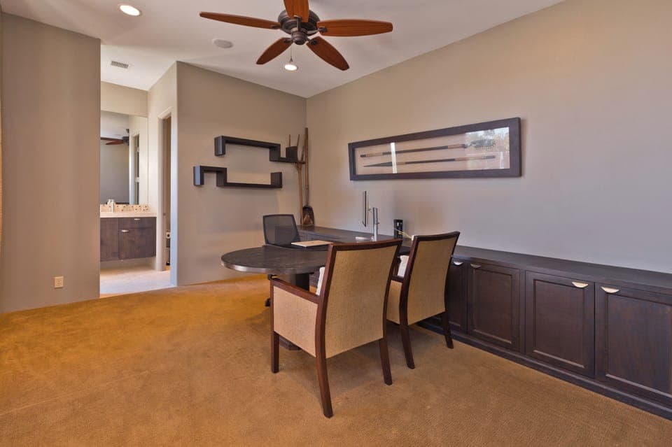 Office with high-speed internet, partner desk, monitor, and en-suite bath. 