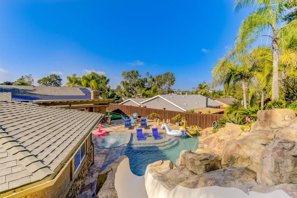 Huge 20' custom slide lands into 8 foot deep of perfectly heated saltwater pool.