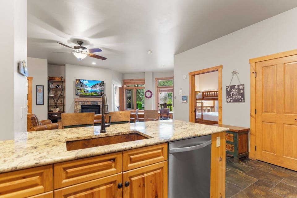 Full kitchen with stainless steel appliances and breakfast bar seating.