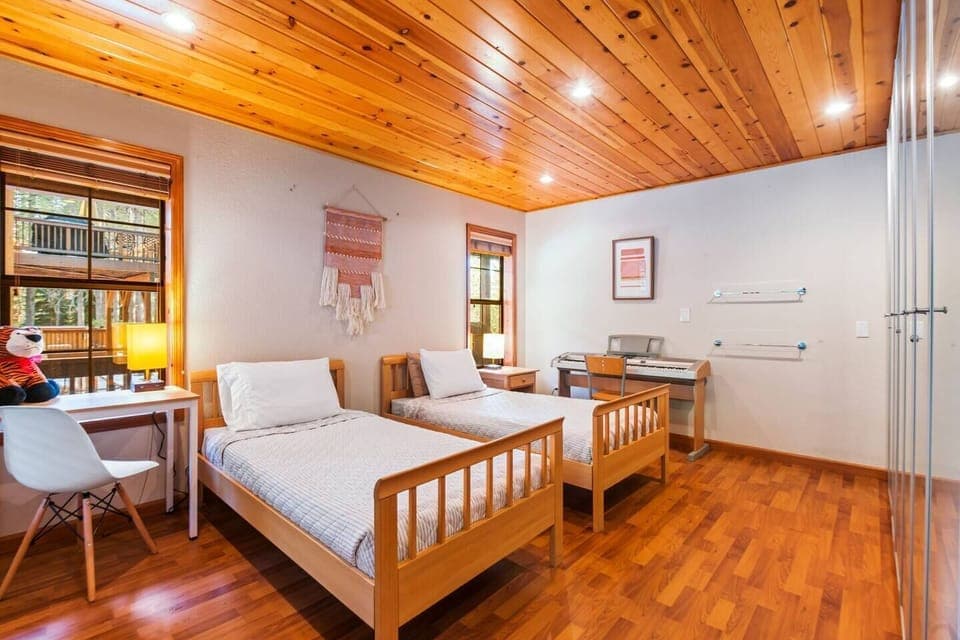 Bedroom 4. Two single beds that can be joined to make a king bed. Work desk and chair. Full bath across the hallway.