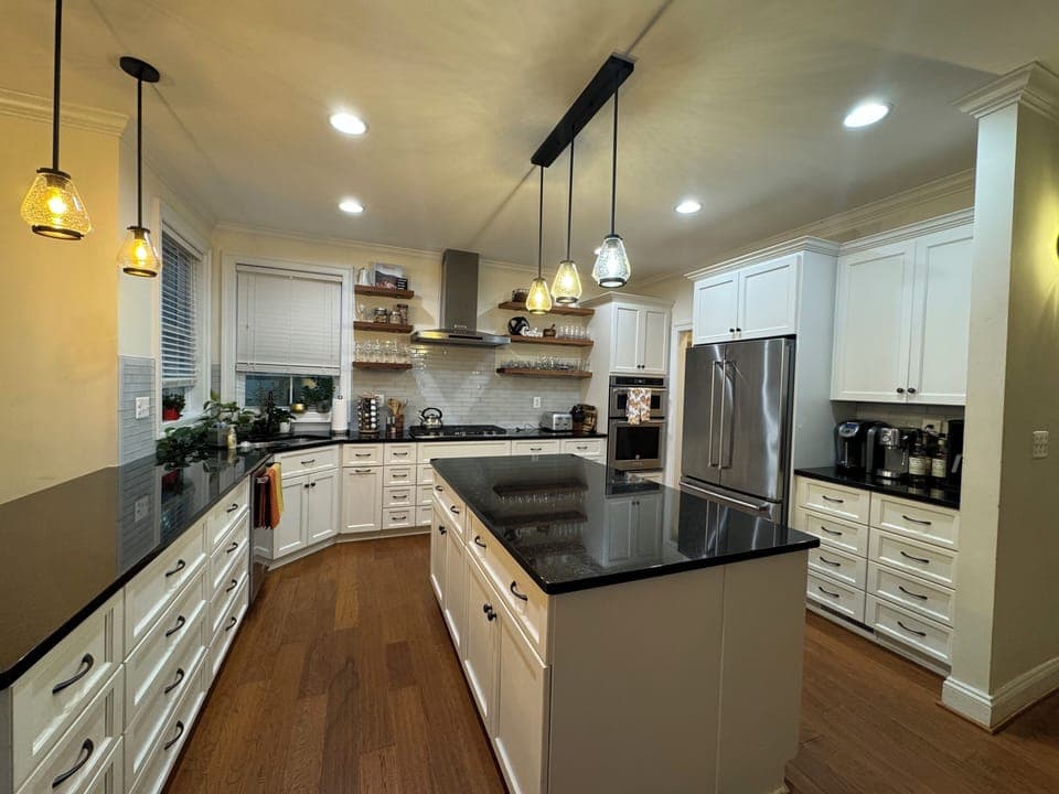 Fully stocked kitchen with cooking and baking utensils, spices, coffee makers