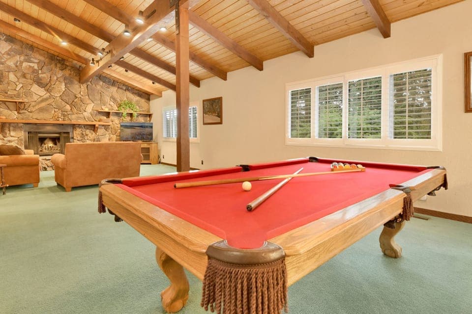 Upstairs game room with pool table and cozy family space, perfect for fun, relaxation, and memorable guest gatherings