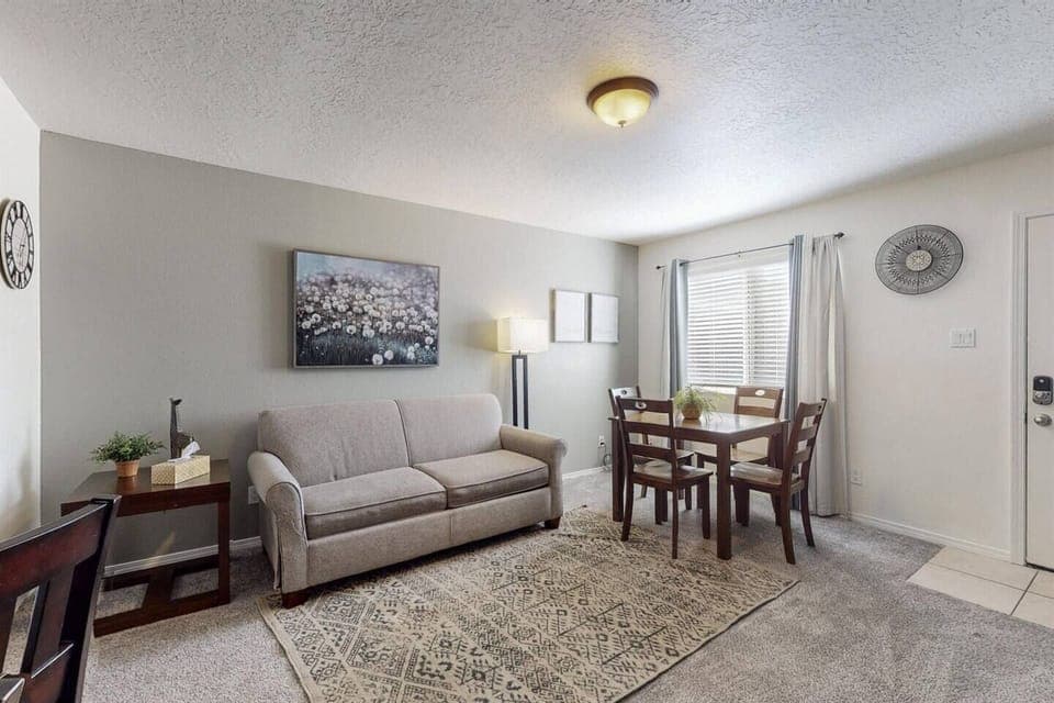 Living room with table to be used to have meals at or use to set up a work station