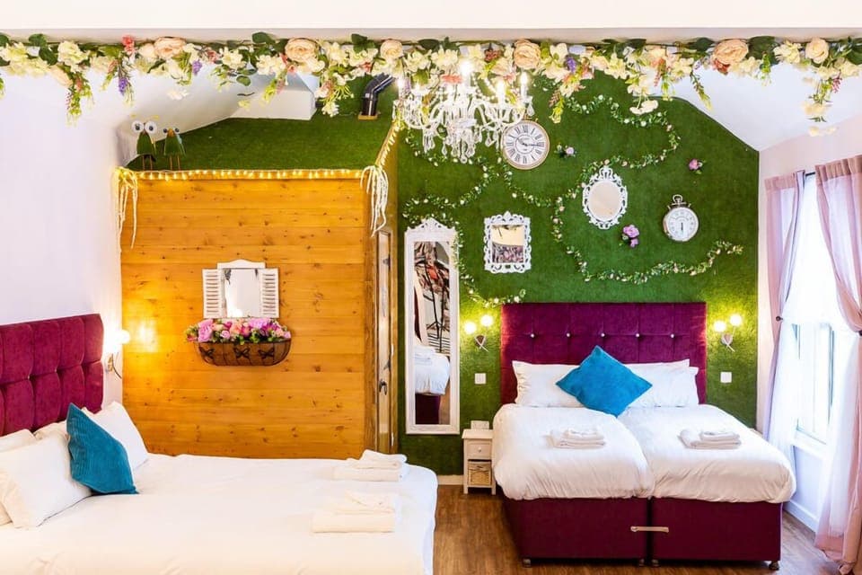 Grass wall with flowers, clocks and mirrors 