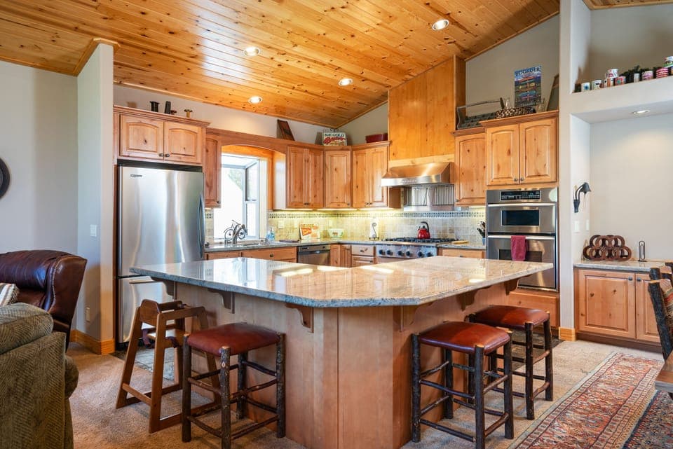 Spacious kitchen with chef-grade appliances, granite countertops, and a breakfast bar—everything you need to create your favorite meals.